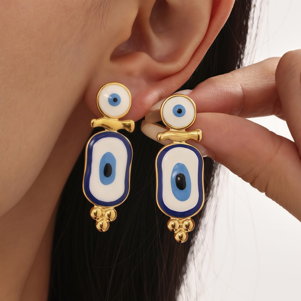 Model wearing cosmic energy-inspired evil eye earrings for spiritual style