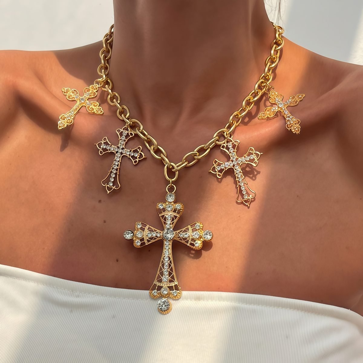 Model wearing celestial cross necklace for strength and spiritual focus