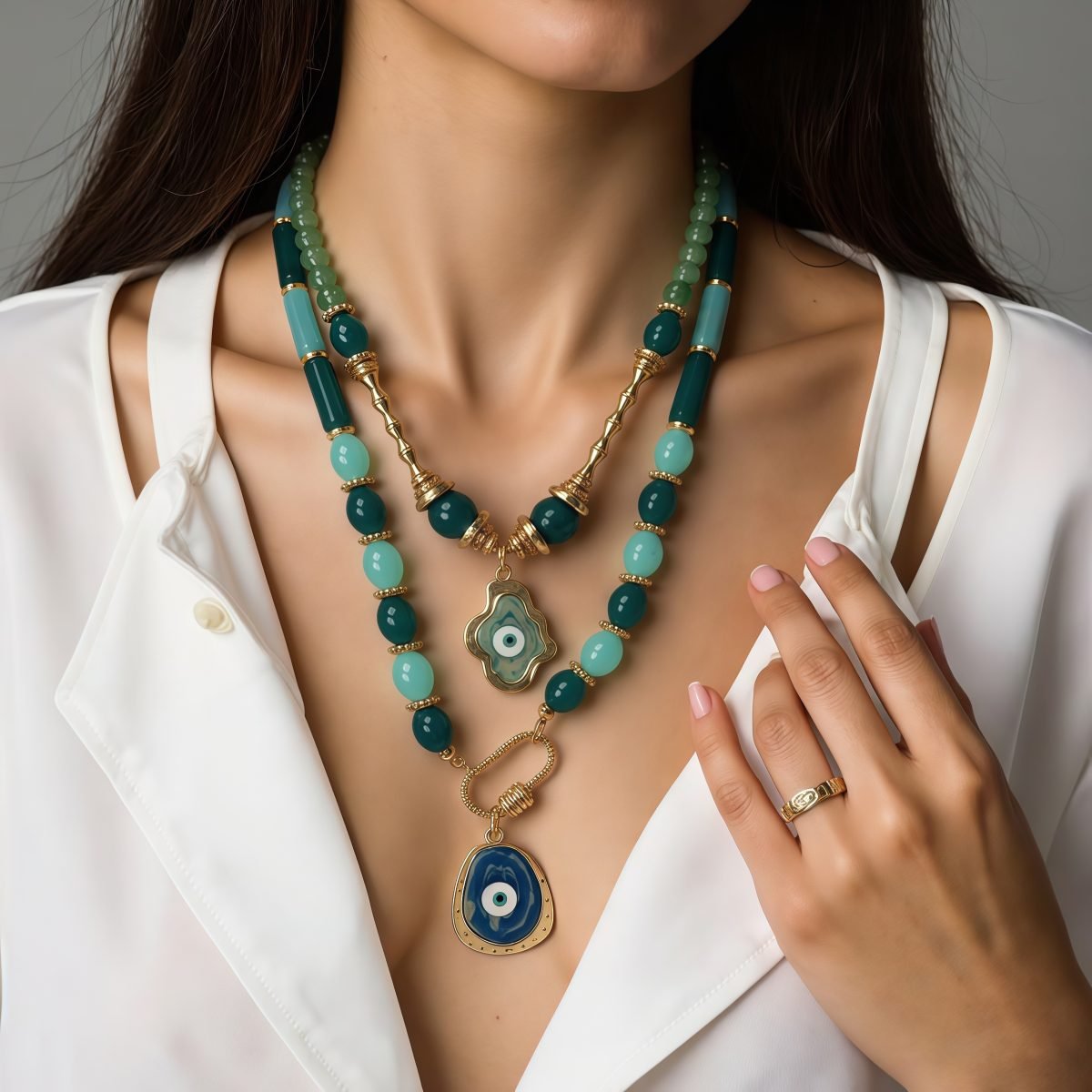 Model wearing layered evil eye necklace with cosmic energy symbolism for spiritual protection