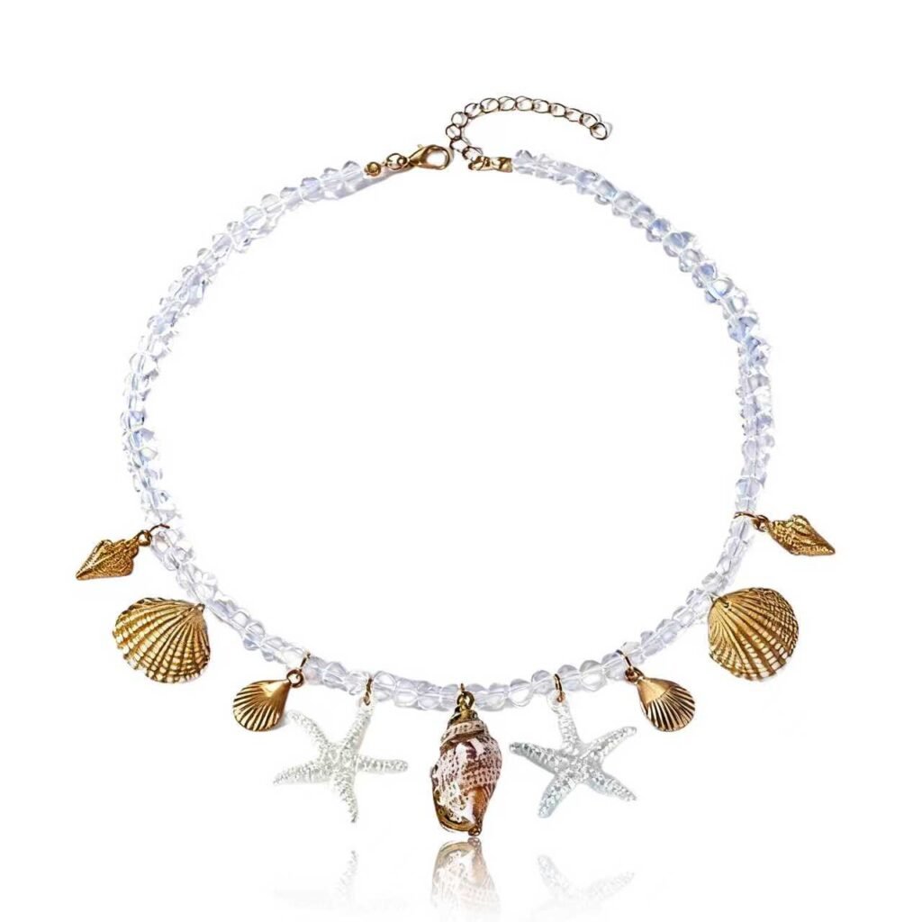 Cosmic Tide Pearls Necklace with pearls, shells, and starfish charms on white background