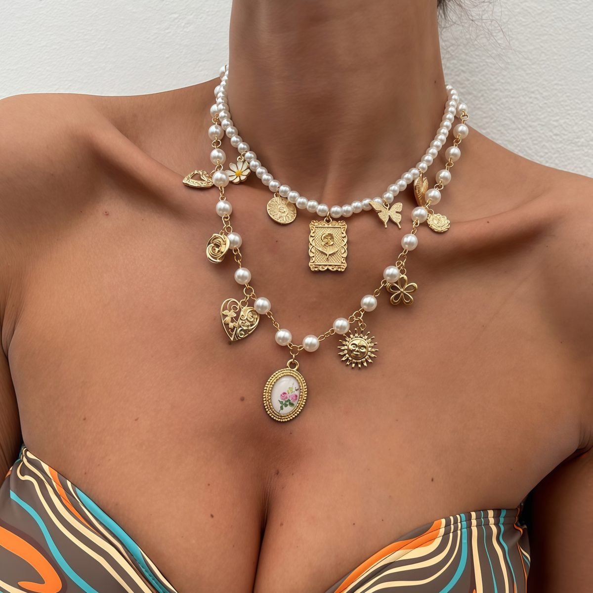 Woman wearing Cosmic Harmony Necklace with butterfly, sun, and heart totems