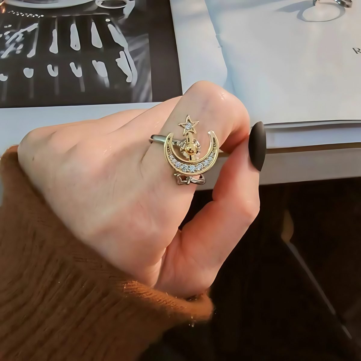 Model wearing Cosmic Moon Ring – Star and Moon Energy Spinner in gold