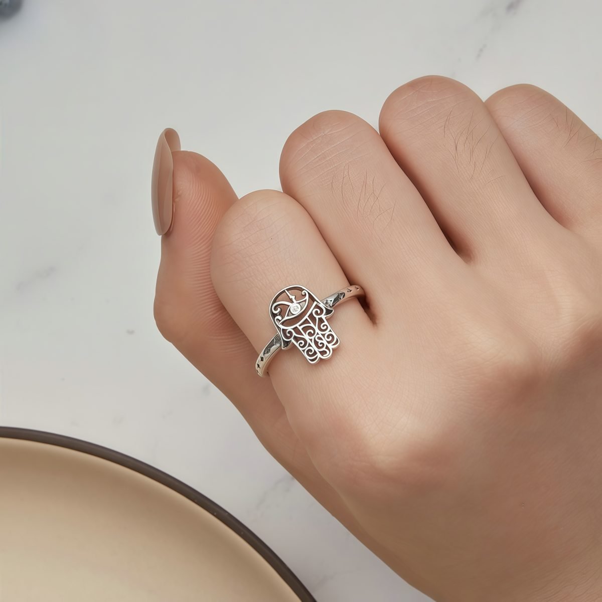 Model wearing Celestial Harmony Adjustable Silver Hamsa Ring with diamond accent