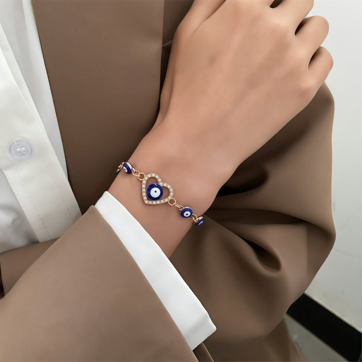 Model wearing Cosmic Soul Energy - Azure Guardian Devil's Eye Bracelet, paired with a brown suit set.