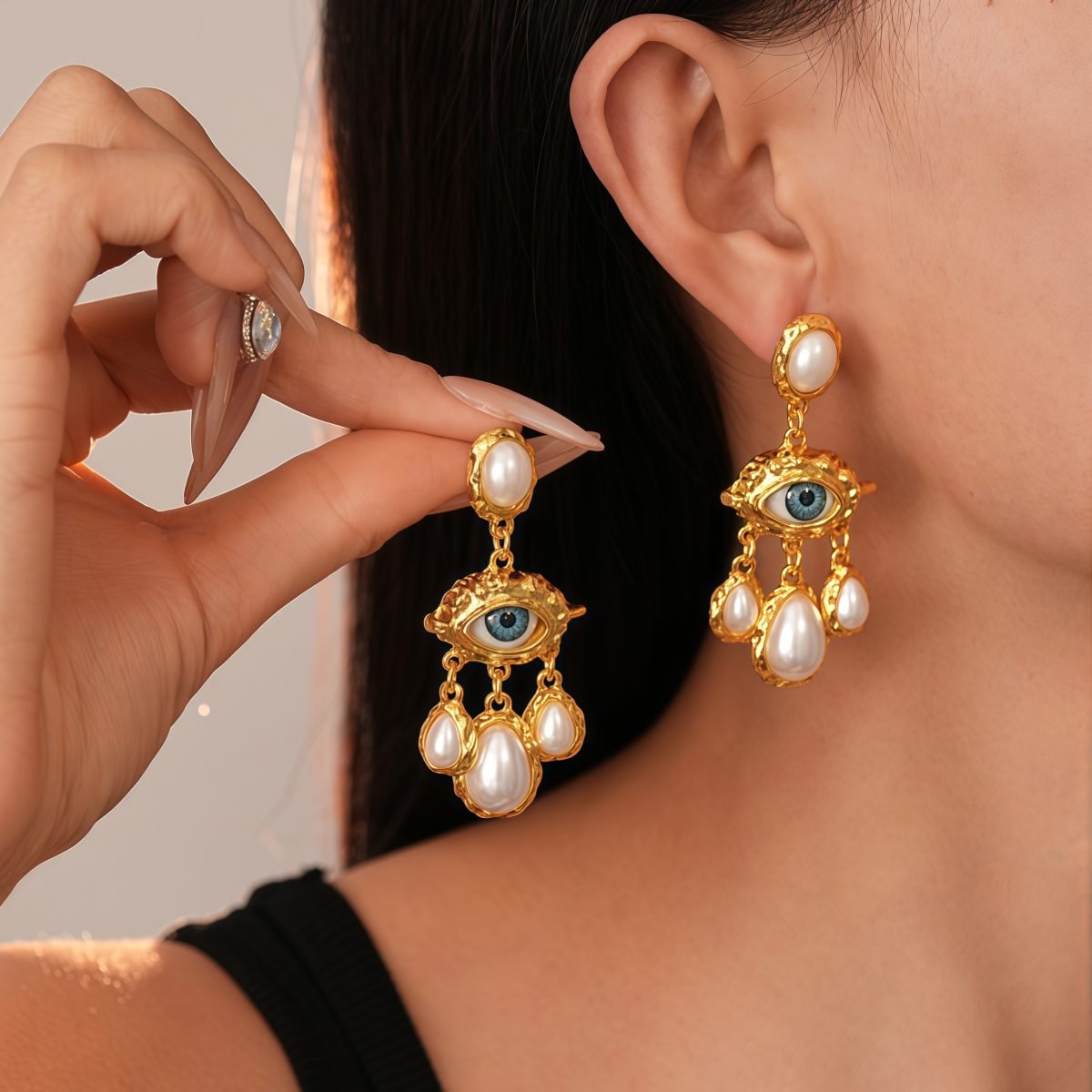 Woman wearing Cosmic Energy Pearl Earrings – Evil Eye & Celestial Guardian showing movement and shine -gold