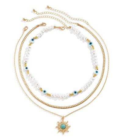 Cosmic Energy pearl and sun trio necklace set on display – layered celestial jewelry