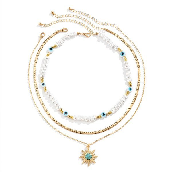 Cosmic Energy pearl and sun trio necklace set on display – layered celestial jewelry
