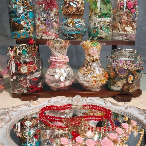 A pile of mysterious jewelry jars are placed on the shelf.