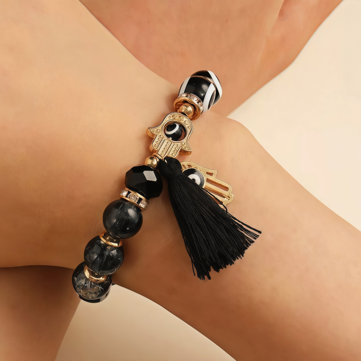 The model is wearing Mystic Black Protection – Evil Eye & Hamsa Tassel Bracelet on her hand.