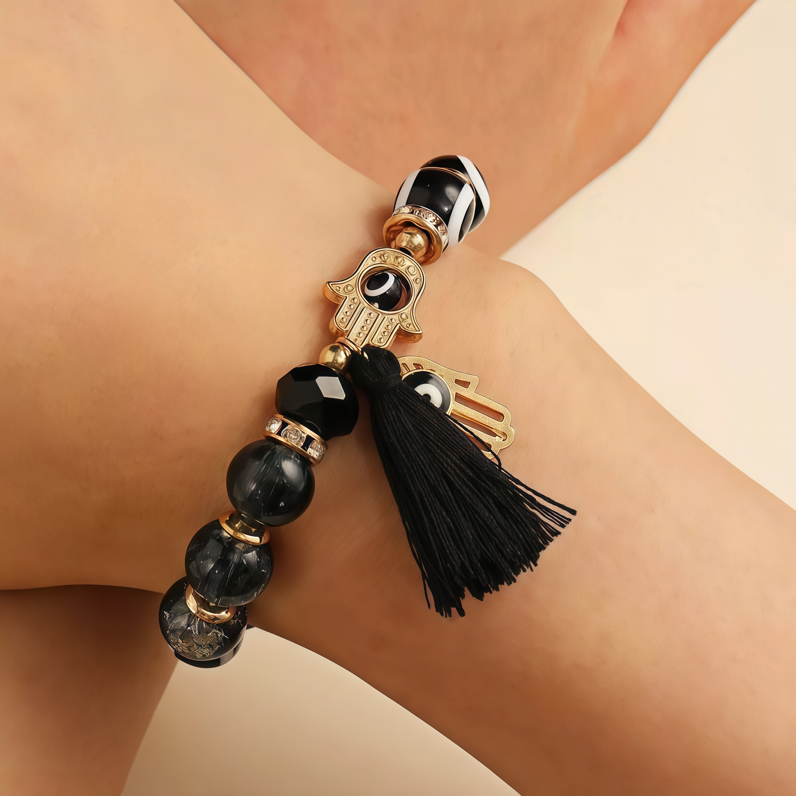 Mystic Blcak Protection – Evil Eye & Hamsa Tassel Bracelet-main vie The model is wearing Mystic Black Protection – Evil Eye & Hamsa Tassel Bracelet on her hand.